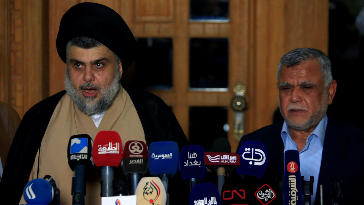 Iraqi Shi'ite cleric Moqtada al-Sadr speaks during a news conference with Leader of the Conquest Coalition and the Iran-backed Shi'ite militia Badr Organisation Hadi al-Amiri, in Najaf Iraqi Shi'ite cleric Moqtada al-Sadr speaks during a news conference with Leader of the Conquest Coalition and the Iran-backed Shi'ite militia Badr Organisation Hadi al-Amiri, in Najaf, Iraq June 12, 2018. REUTERS/Alaa al-Marjani - RC1820CC66C0