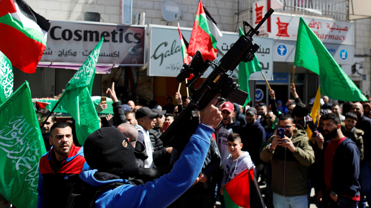 ISRAEL-PALESTINIANS/ A gunman holds a weapon during the funeral of Samah Mubarak, in Ramallah in the Israeli-occupied West Bank March 9, 2019. REUTERS/Mohamad Torokman - RC1FBCB4BD50