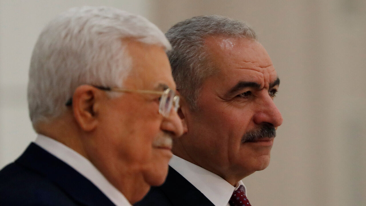 ISRAEL-PALESTINIANS/POLITICS New Palestinian Prime Minister Mohammad Shtayyeh stands next to President Mahmoud Abbas during a swearing in ceremony of a new government, in Ramallah in the Israeli-occupied West Bank April 13, 2019. REUTERS/Mohamad Torokman - RC1F397216C0