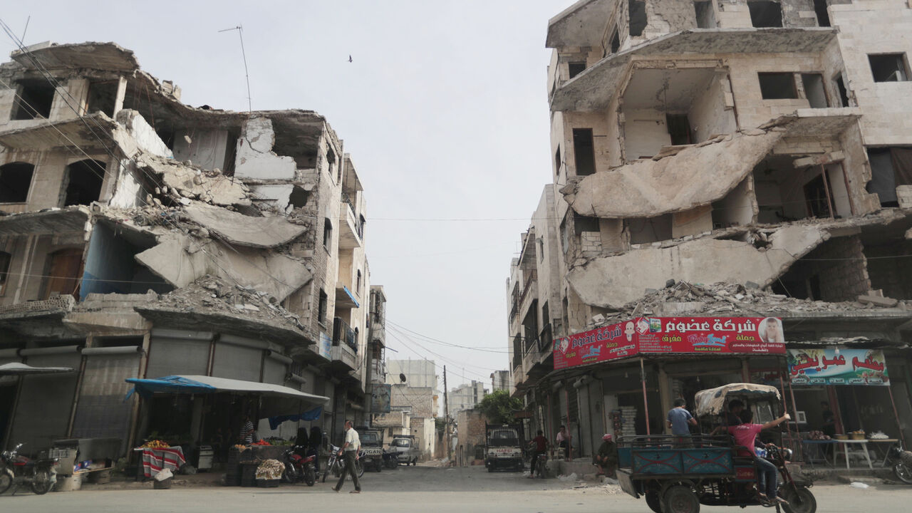SYRIA-SECURITY/NORTHWEST A man walks past damaged buildings in the city of Idlib, Syria May 24, 2019. REUTERS/Khalil Ashawi - RC1D4BDCBD50