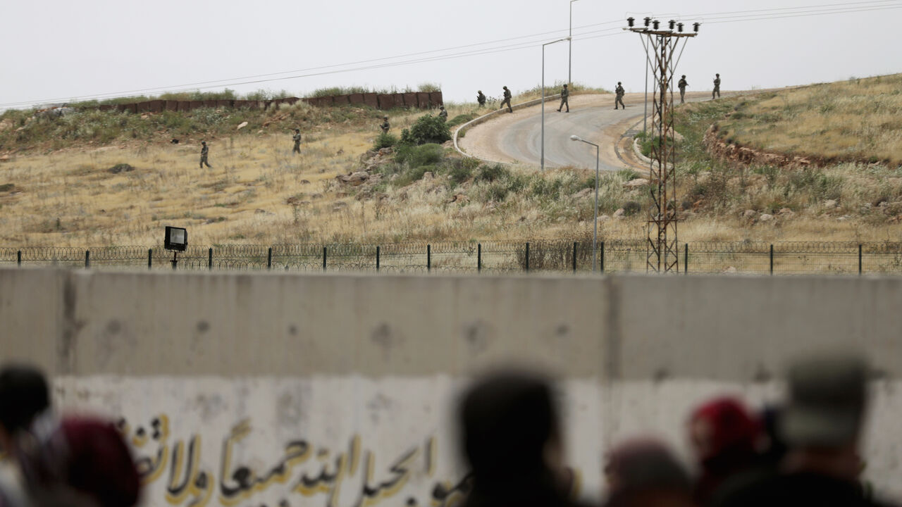 TURKEY-RUSSIA/SYRIA Turkish soldiers walk at the Atmeh crossing on the Syrian-Turkish border, as seen from the Syrian side, in Idlib governorate, Syria May 31, 2019. REUTERS/Khalil Ashawi - RC17B93A8C20