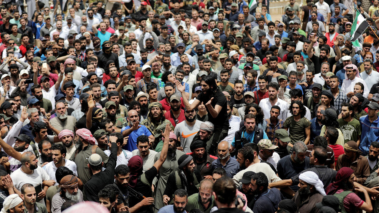 People gather during the funeral of Abdelbasset al-Sarout, 27, who died from wounds he sustained battling in northwest Syria, in the border town of al-Dana, Idlib, Syria June 9, 2019. REUTERS/Khalil Ashaw - RC16B44F3FF0
