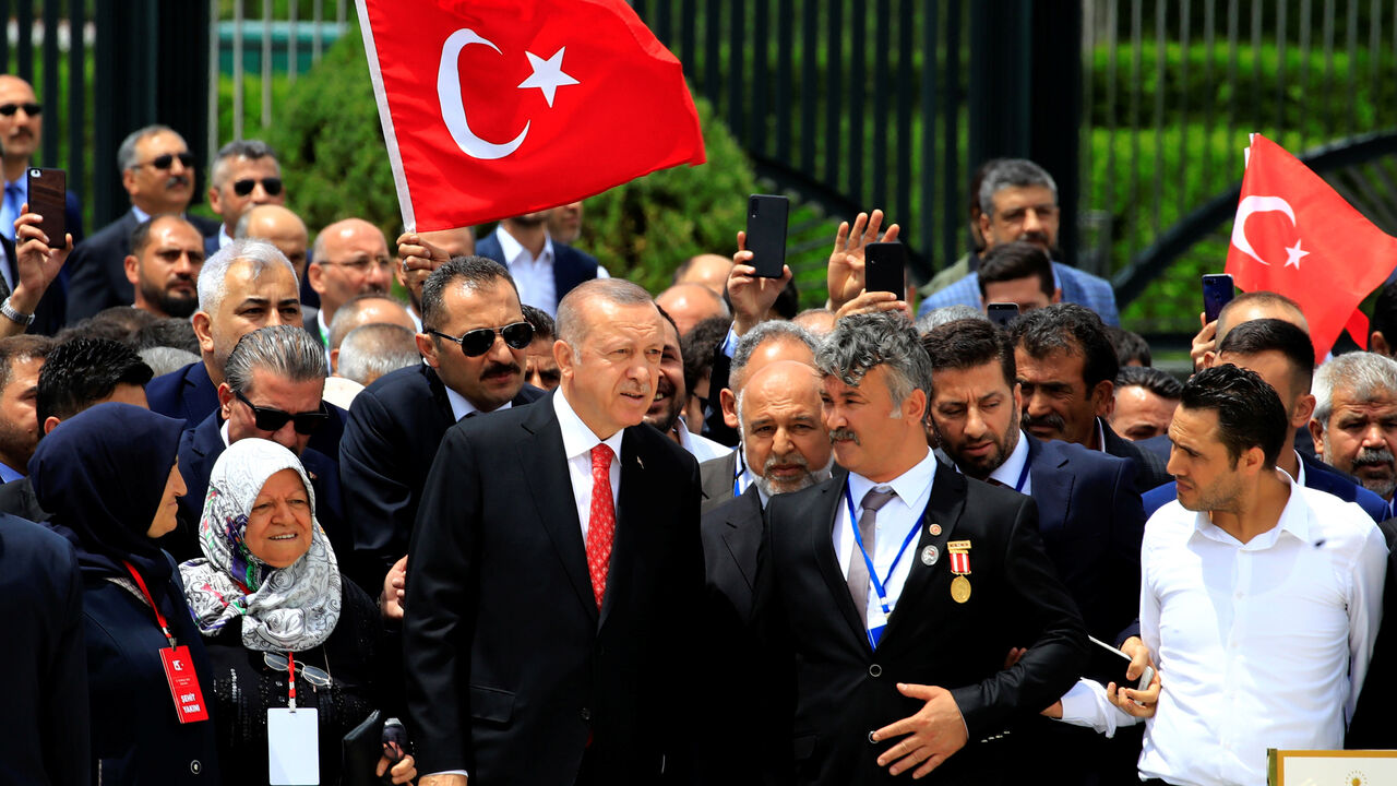 TURKEY-SECURITY/ Turkish President Tayyip Erdogan visits a monument as he is flanked by his supporters during a ceremony marking the third anniversary of the attempted coup, at the Presidential Palace in Ankara, Turkey, July 15, 2019. REUTERS/Umit Bektas - RC11458C43B0