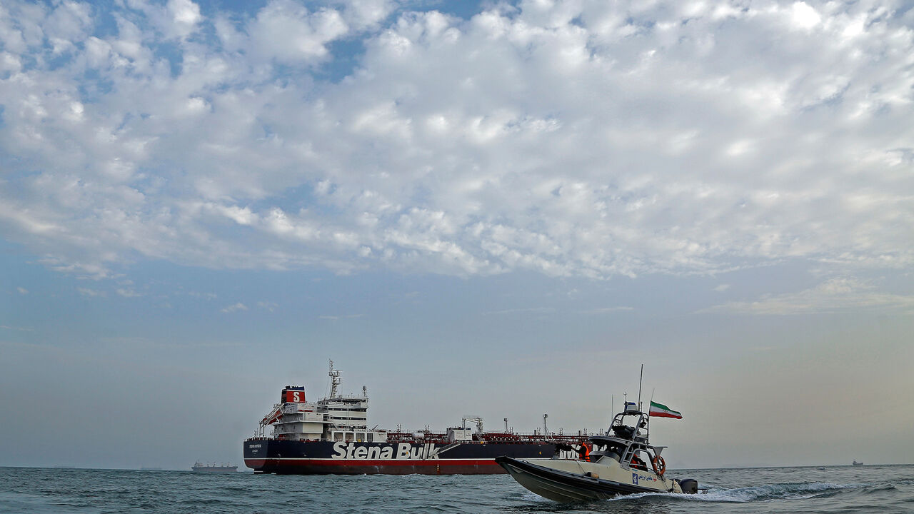 MIDEAST-IRAN/TANKER A boat of the Iranian Revolutionary Guard sails next to Stena Impero, a British-flagged vessel owned by Stena Bulk, at Bandar Abbas port, July 21, 2019. Picture taken July 21, 2019. Iran, Mizan News Agency/WANA Handout via REUTERS ATTENTION EDITORS - THIS IMAGE WAS PROVIDED BY A THIRD PARTY. - RC1EE6EC1840