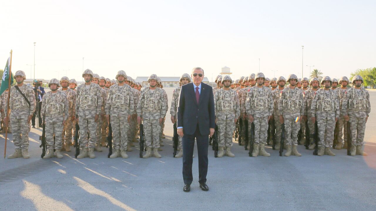 874489504 DOHA, QATAR - NOVEMBER 15: President of Turkey Recep Tayyip Erdogan poses for a photo with soldiers during his visit at the Qatari-Turkish Armed Forces Land Command base in Doha, Qatar on November 15, 2017. (Photo by Kayhan Ozer/Anadolu Agency/Getty Images)