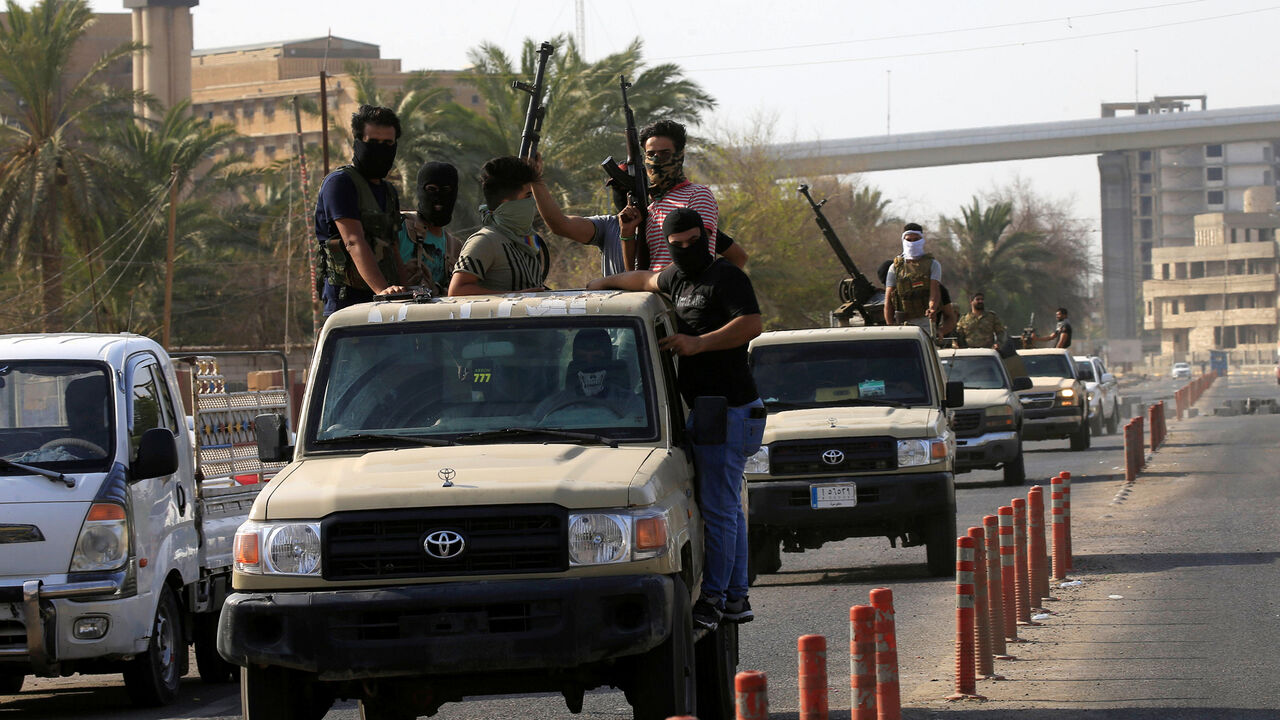 IRAQ-PROTESTS/ Vehicles of Iraq's Popular Mobilization Forces, are seen near the building belonging to Popular Mobilization Forces in Basra, Iraq September 8, 2018. REUTERS/Alaa al-Marjani - RC1A26D72410