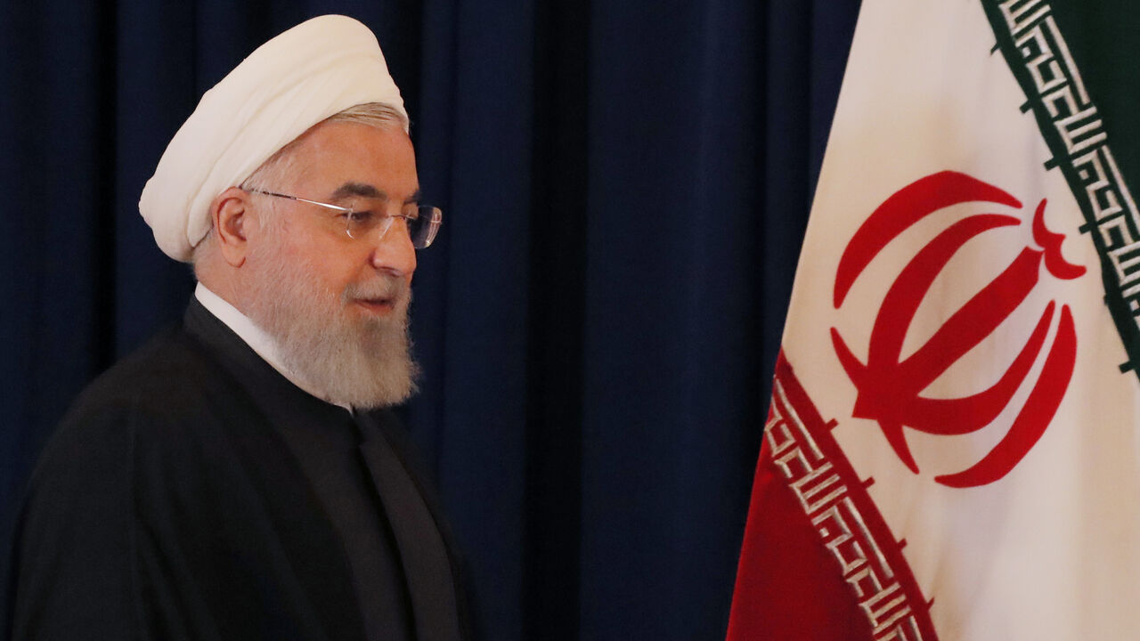 Iran's President Hassan Rouhani at a news conference on the sidelines of the General Assembly in New York Iran's President Hassan Rouhani walks by his country's flag at a news conference on the sidelines of the 73rd session of the United Nations General Assembly at U.N. headquarters in New York, U.S., September 26, 2018. REUTERS/Brendan Mcdermid - HP1EE9Q1DYAGU