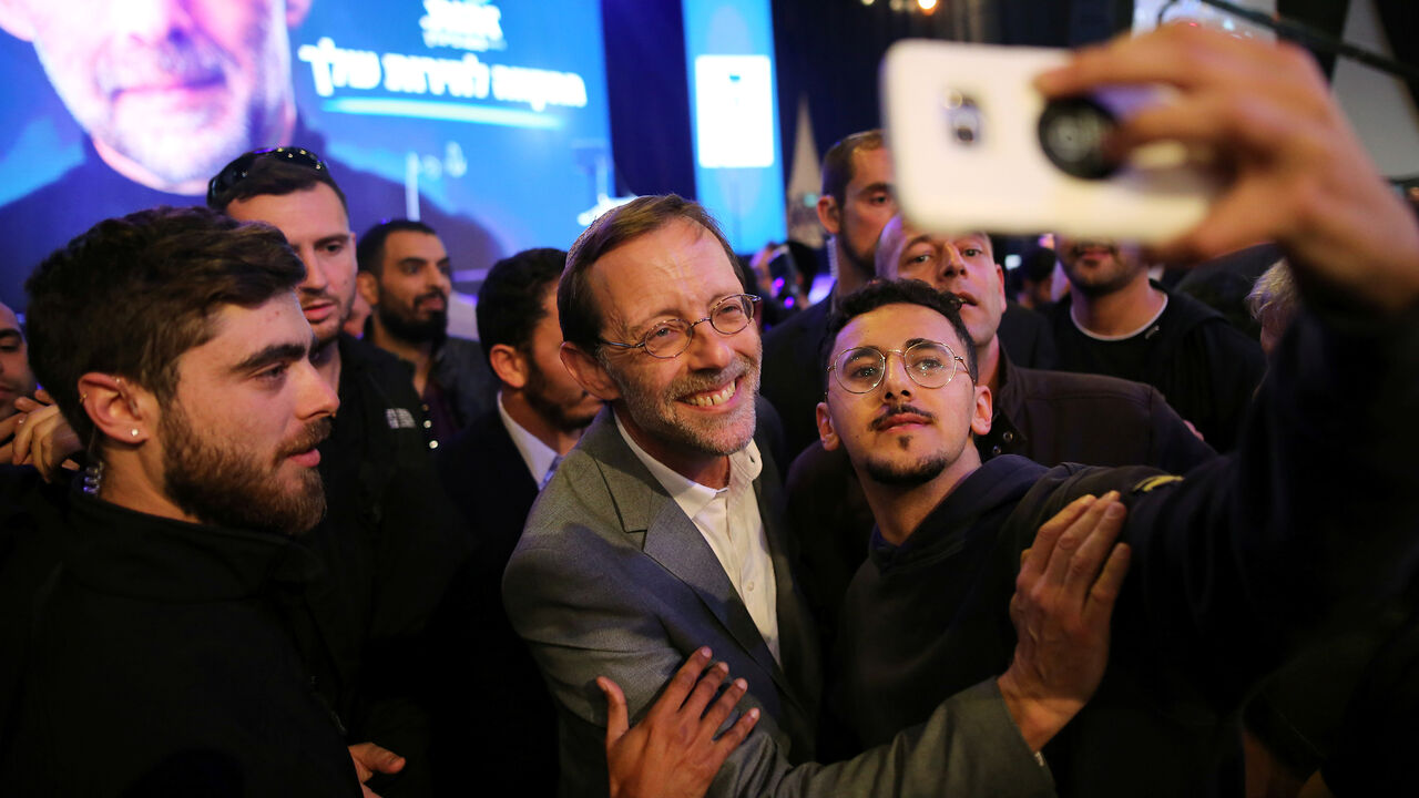 ISRAEL-ELECTION/FEIGLIN Moshe Feiglin, leader of Zehut, an ultra-nationalist religious party, poses for a selfie with supporters at an election campaign event in Tel Aviv, Israel April 2, 2019. Picture taken April 2, 2019. REUTERS/Corinna Kern - RC1FE25CD6B0