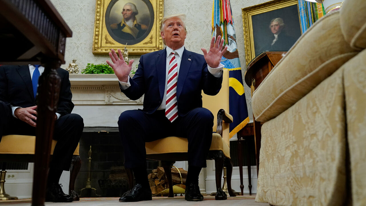 USA-TRUMP/ U.S. President Donald Trump answers questions from reporters while sitting in front of portraits of former U.S. presidents George Washington and Thomas Jefferson as he meets with Romania's President Klaus Iohannis in the Oval Office of the White House in Washington, U.S. August 20, 2019. REUTERS/Kevin Lamarque - RC16D514D880
