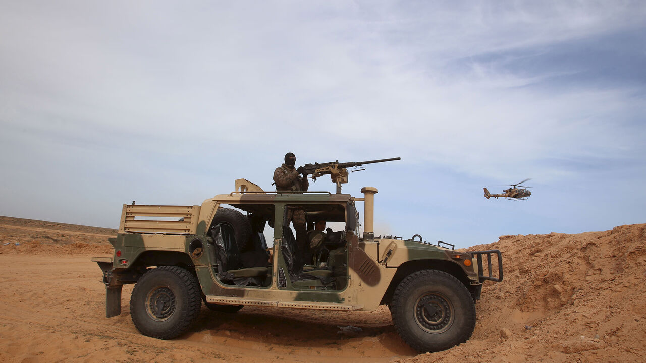 TUNISIA-SECURITY/ A Tunisian soldier holds his position during an exercise along the frontier with Libya in Sabkeht Alyun, Tunisia February 6, 2016. Tunisia has completed a 200-km (125 mile) barrier along its frontier with Libya to try to keep out Islamist militants, and will soon install electronic monitoring systems, Defence Minister Farhat Hachani said on Saturday. REUTERS/Zoubeir Souissi TPX IMAGES OF THE DAY - GF10000298826