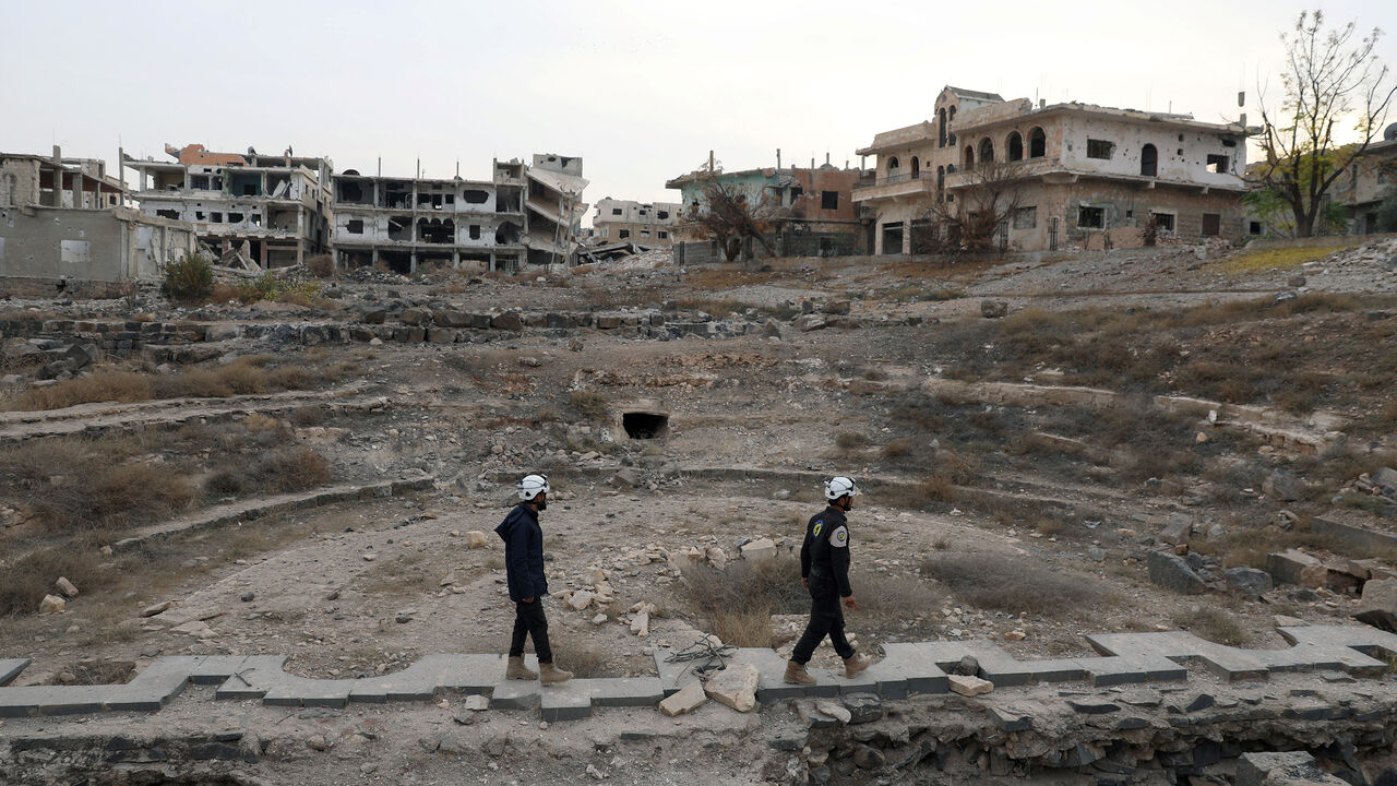 MIDEAST-CRISIS/SYRIA Members of the Civil Defence, also known as the 'White Helmets', are seen inspecting the damage at a Roman ruin site in Daraa, Syria December 23, 2017. REUTERS/Alaa al-Faqir - RC1DDC3A3F50