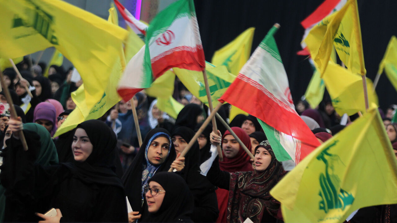 1094551698 06 February 2019, Lebanon, Beirut: Supporters of Hezbollah, the pro-Iranian Lebanese Islamist political party and militant group, wave flags of Iran and Hezbollah during a rally to mark the 40th anniversary of the Iranian Islamic Revolution which toppled Mohammad Reza Pahlavi, the last Shah of Iran. Photo: Marwan Naamani/dpa (Photo by Marwan Naamani/picture alliance via Getty Images)