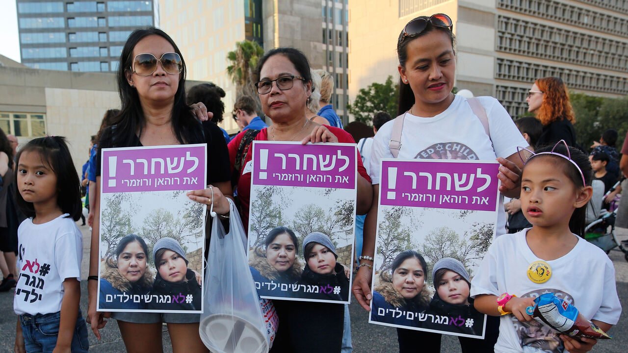 1160071433 Filipino children and their mothers carry a banner which reads in Hebrew "release Filipina mother and her son" during a protest against deportation in Tel Aviv on August 6, 2019. - Hundreds of people demonstrated in Israel against the deportation of Filipino children born in Israel from migrant workers but without any legal status. (Photo by Gil COHEN-MAGEN / AFP) (Photo credit should read GIL COHEN-MAGEN/AFP/Getty Images)