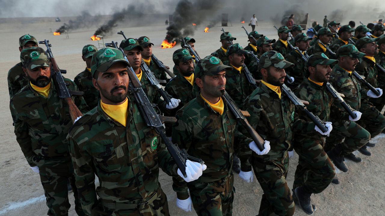 IRAQ-MILITIAS/ Members of the paramilitary Popular Mobilisation Forces (PMF) take part in their graduation ceremony at a military camp in Kerbala, Iraq August 30, 2019. REUTERS/Abdullah Dhiaa Al-Deen - RC1D99820E90