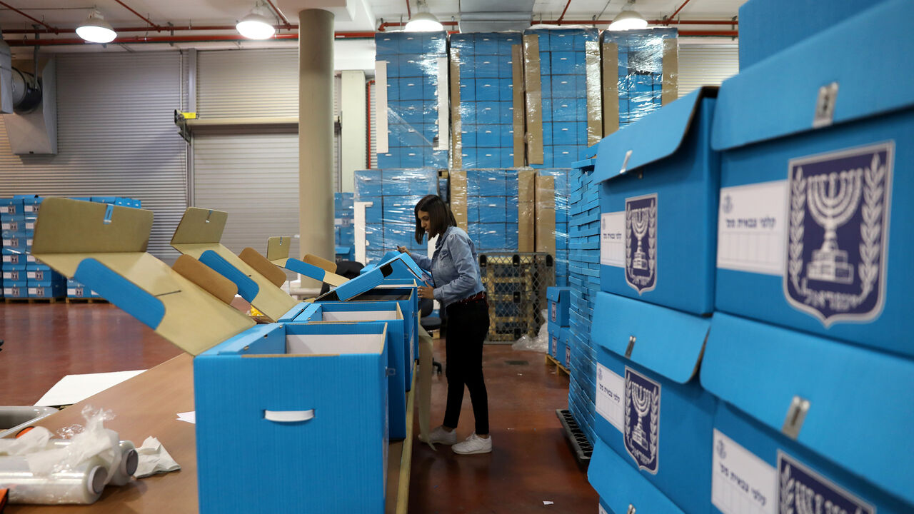 ISRAEL-ELECTION/PREPARATIONS A woman sorts ballot boxes as part of preparations for the upcoming Israeli election, during a briefing for members of the media at the Israel Central Election Committee Logistics Center in Shoham, Israel March 6, 2019. REUTERS/Ammar Awad - RC194FCE0D70