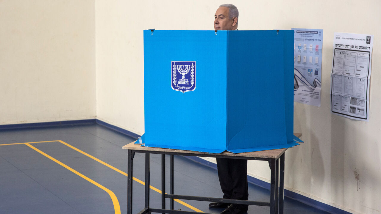 ISRAEL-ELECTION/NETANYAHU VOTES Israeli Prime Minister Benjamin Netanyahu stands behind a voting booth as he votes during Israel's parliamentary election at a polling station in Jerusalem September 17, 2019. Heidi Levine/Pool via REUTERS - RC1B8144FA90