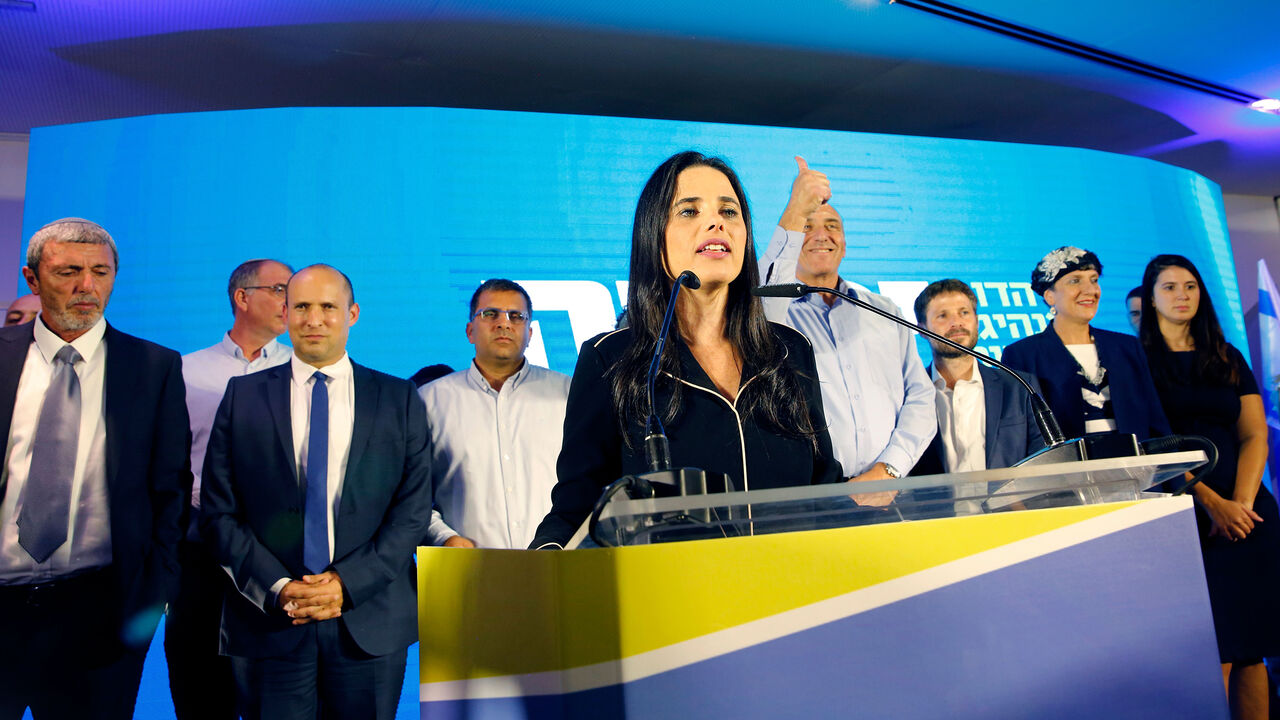 1168934704 Ayelet Shaked (C), leader and candidate of the New Right party that is part of the Yamina political alliance, speaks while flanked by New Right party member and candidate Naftali Bennett (2nd-L) and Jewish Home party leader and candidate Rafi Peretz (L), at the alliance's headquarters in Ramat Gan, north of Tel Aviv, late on September 17, 2019, as the first exit polls are announced on television. - Israeli Prime Minister Benjamin Netanyahu and his main challenger Benny Gantz were neck-and-neck in the countr