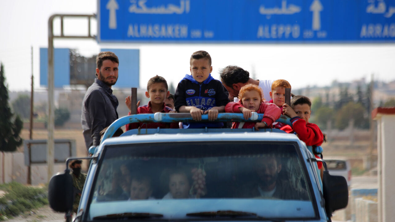 1175846259 Syrians return to their homes in the town of Ayn al-Arus, south of the border town of Tal Abyad, on October 14, 2019, after it was taken over by Turkish-backed Syrian fighters during their assault on Kurdish-held border towns in northeastern Syria. - Syrian regime forces moved towards the Turkish border after Damascus reached a deal with beleaguered Kurdish forces following a US withdrawal announcement, AFP correspondents reported. (Photo by Bakr ALKASEM / AFP) (Photo by BAKR ALKASEM/AFP via Getty Images)