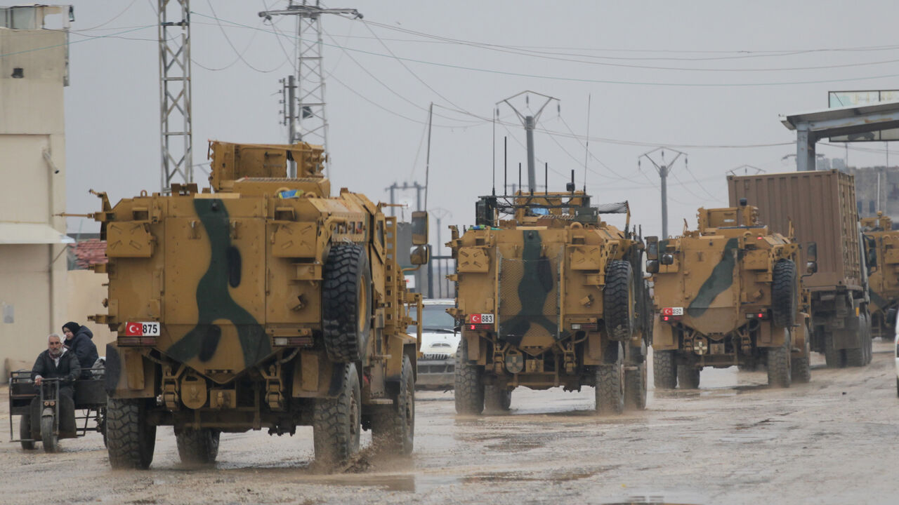 MIDEAST-CRISIS/SYRIA-REBELS Turkish military vehicles ride at the Bab el-Salam border crossing between the Syrian town of Azaz and the Turkish town of Kilis, in Syria January 1, 2019. Picture taken January 1, 2019. REUTERS/Khalil Ashawi - RC1AD1B9E6A0