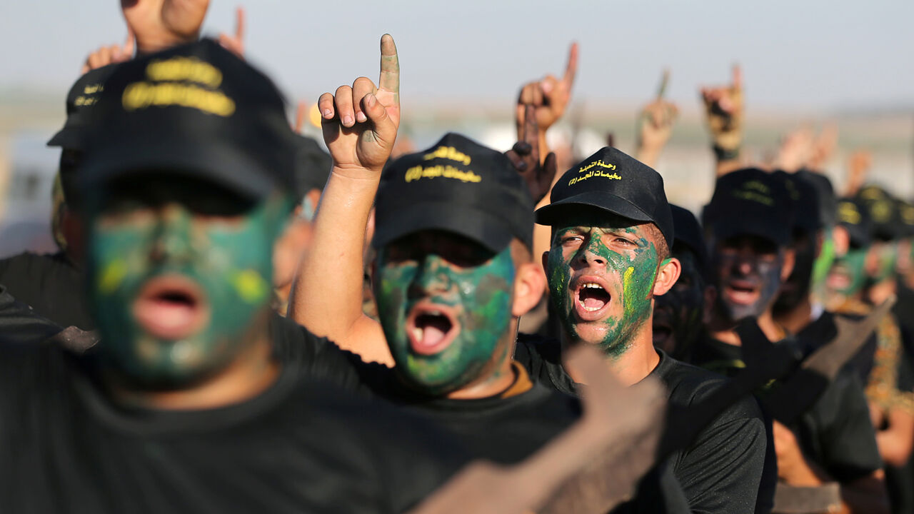 ISRAEL-PALESTINIANS/MILITARY Young Palestinians have their faces painted as they chant slogans during a military-style graduation ceremony at a summer camp organised by Islamic Jihad, in Gaza City July 4, 2019. REUTERS/Ibraheem Abu Mustafa - RC1549743970