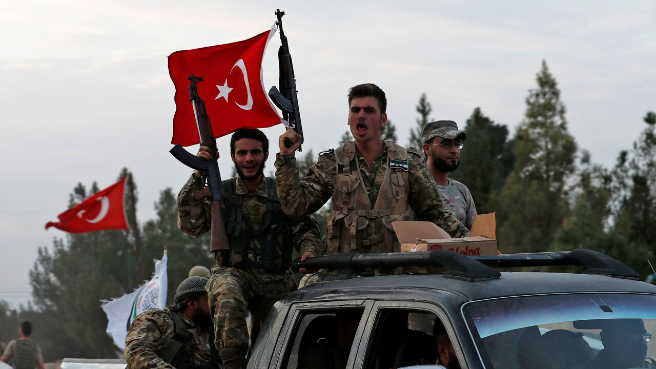 SYRIA-SECURITY/TURKEY-USA Turkey-backed Syrian rebel fighters drive on top of a truck to cross into Syria, near the border town of Akcakale in Sanliurfa province, Turkey, October 17, 2019. REUTERS/Murad Sezer - RC11C9239EE0