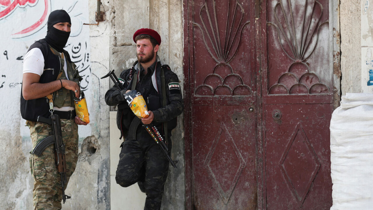 SYRIA-SECURITY/TURKEY Turkey-backed Syrian rebel fighters patrol in the border town of Tal Abyad, Syria, October 21, 2019. REUTERS/Khalil Ashaw - RC1B682B5390