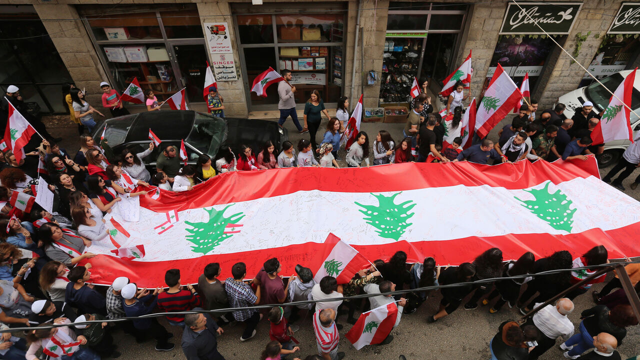 LEBANON-PROTESTS/ Demonstrators carry Lebanese flags during an anti-government protest in the mainly Druze town of Hasbaya, Lebanon October 25, 2019. REUTERS/Aziz Taher - RC1D8675FAA0