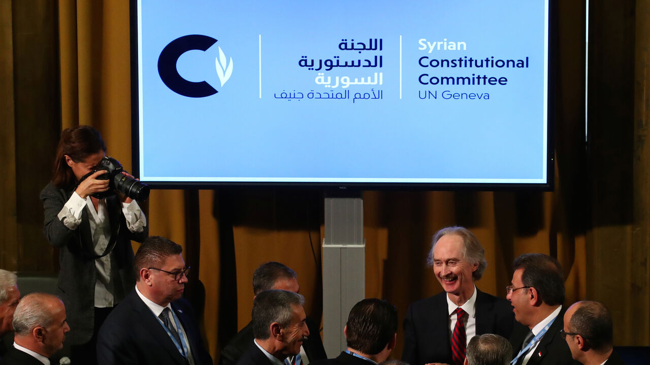 SYRIA-SECURITY/UN U.N. Special Envoy for Syria Geir Pedersen talks with Ahmad Kuzbari, co-chair for the Syrian Government, and other members ot their delegation after the first meeting of the new Syrian Constitutional Committee at the United Nations in Geneva, Switzerland, October 30, 2019. REUTERS/Denis Balibouse - RC145F453450