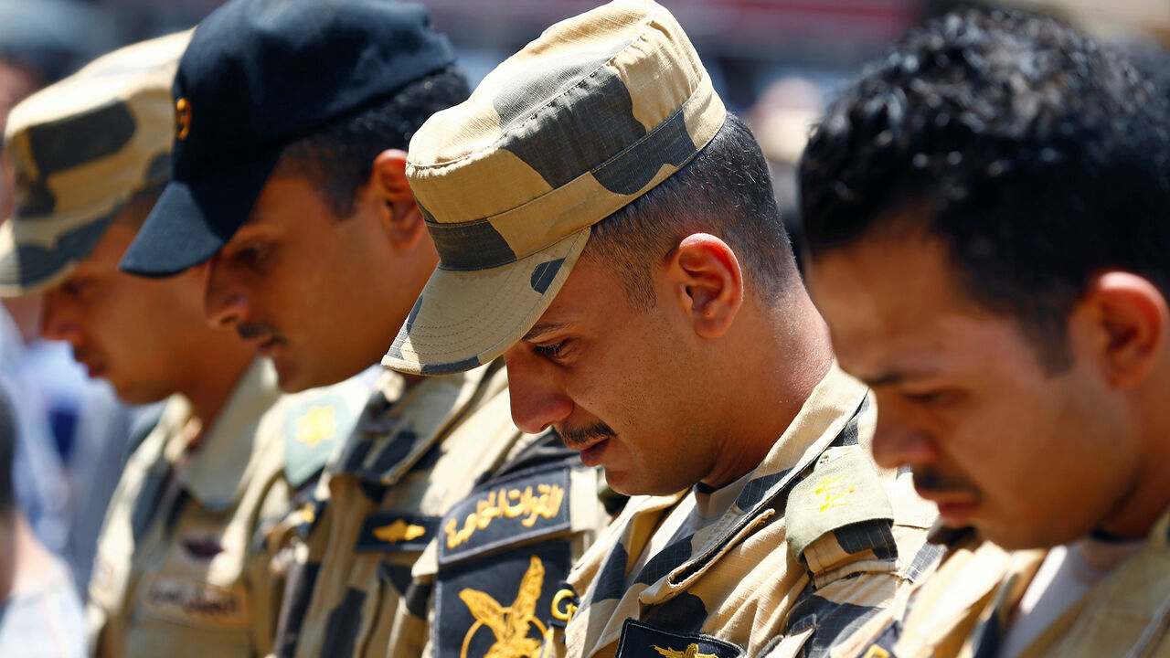 EGYPT-SECURITY/ Egyptian army officers react during the funeral of officer Khaled al-Maghrabi, who was killed during a suicide bomb attack on an army checkpoint in Sinai, in his hometown Toukh, Al Qalyubia Governorate, north of Cairo, Egypt 8 July, 2017. REUTERS/Mohamed Abd El Ghany - RC15CBC45300