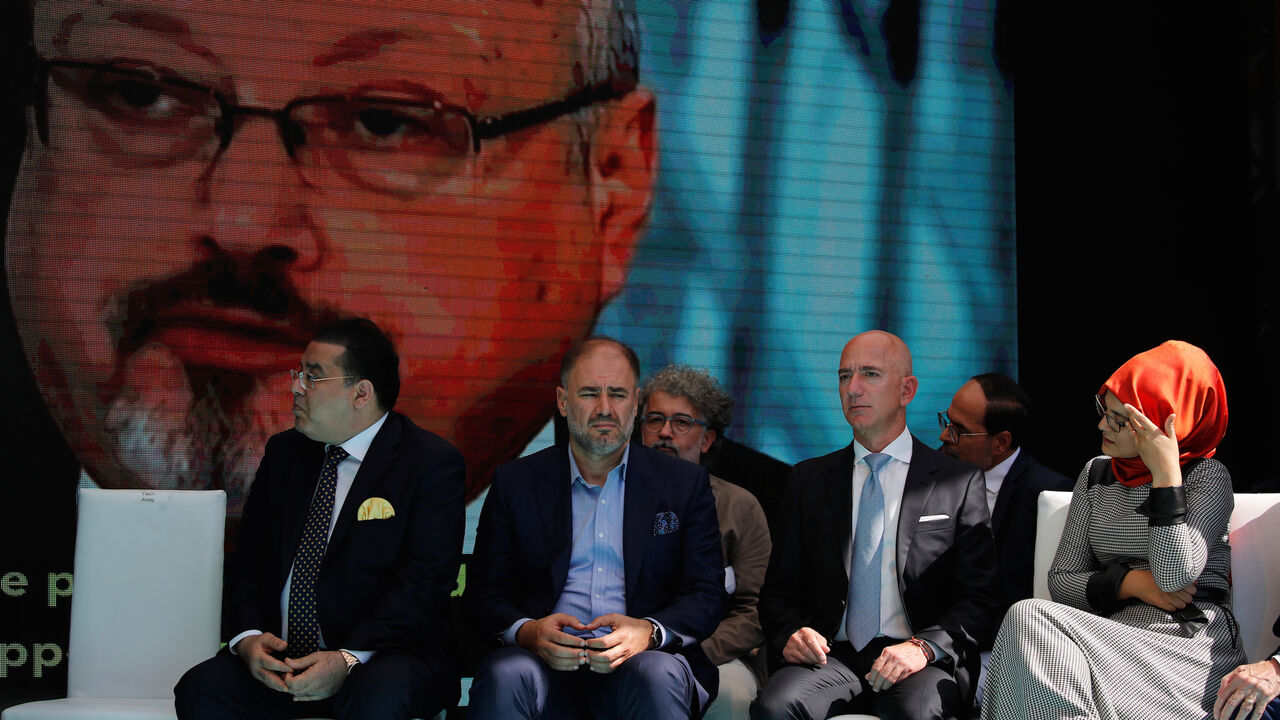 SAUDI-KHASHOGGI/MEMORIAL Hatice Cengiz, fiancee of the murdered Saudi journalist Jamal Khashoggi, and Jeff Bezos, founder of Amazon and Blue Origin, are flanked by attendees as they attend a ceremony marking the first anniversary of Khashoggi's killing at the Saudi Consulate in Istanbul, Turkey, October 2, 2019. REUTERS/Umit Bektas - RC15DF9D2FB0