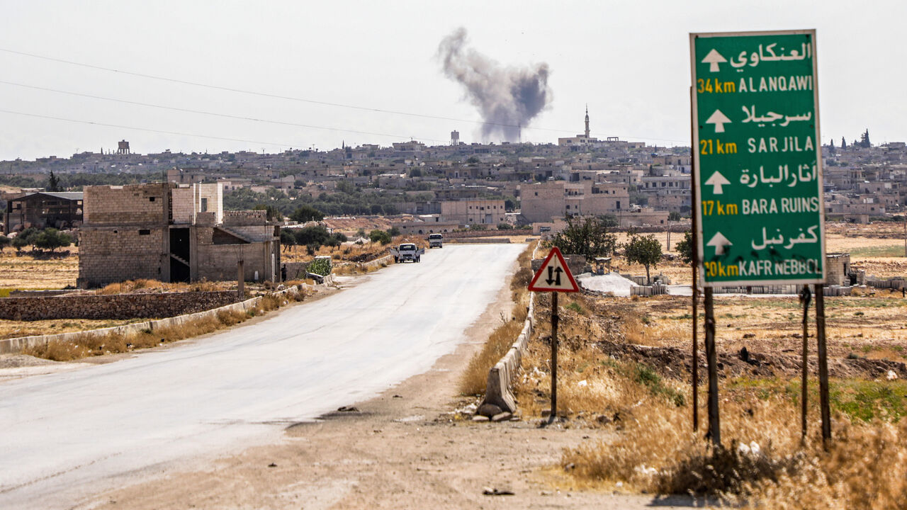 1162012738 This picture taken on August 16, 2019 shows a smoke plume rising following a reported air strike in Kfar Ruma in Syria's northwestern Idlib province. - Air strikes on August 16 by Syria's regime and its Russian ally killed 15 civilians in the area controlled by Syria's former Al-Qaeda affiliate Hayat Tahrir al-Sham (HTS) in Idlib province, said the Britain-based Syrian Observatory for Human Rights. The strikes came as regime forces battled HTS jihadists and allied rebels in the region, where fierce fighting