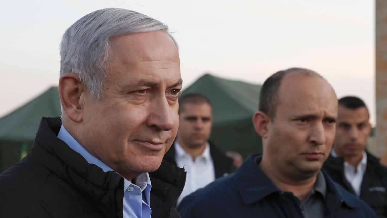1184431376 Israel's Prime Minister Benjamin Netanyahu (L) and Defence Minister Naftali Bennett (2nd) visit an army base in the Israeli-annexed Golan Heights overlooking Syrian territory, on November 24, 2019. (Photo by ATEF SAFADI / POOL / AFP) (Photo by ATEF SAFADI/POOL/AFP via Getty Images)
