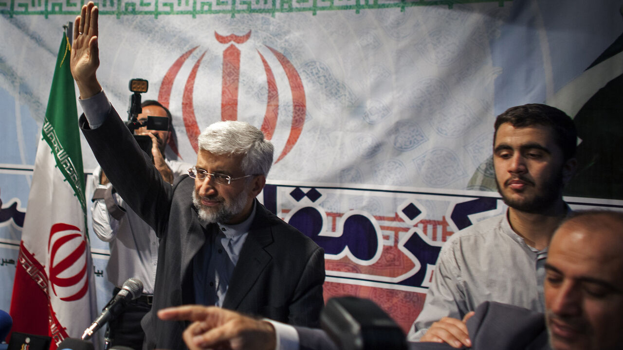 169629163 TEHRAN, IRAN - MAY 29: Iran's top nuclear negotiator and presidential candidate for the upcoming elections, Saeed Jalili, waves during a campaign rally, attended by his female supporters on May 29, 2013 in Tehran, Iran. Jalili, who is running in next month's presidential elections says he will promote a policy of resistance against the West if elected. The elections are scheduled for June 14 and Jalili has stated that he wishes to revive policies of the 1979 Islamic revolution that brought clerics to power.