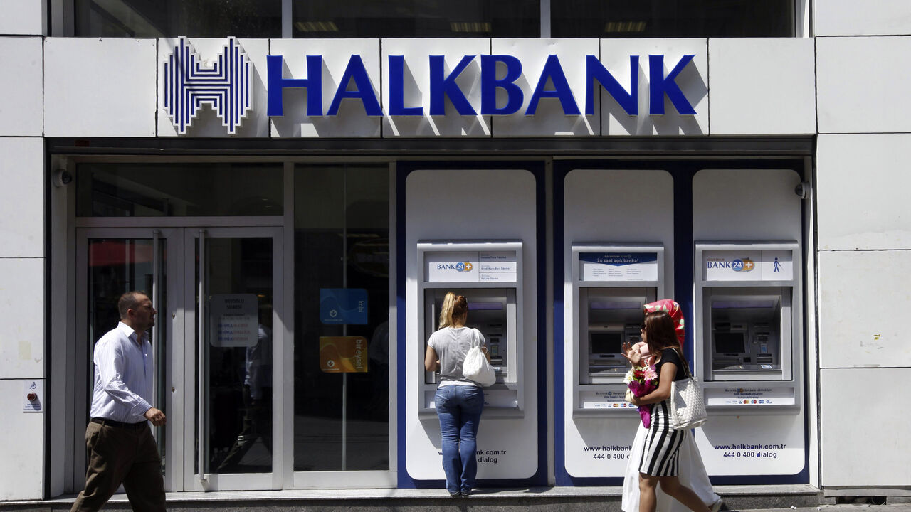 HALKBANK-CACANSKA/ A customer (C) uses an automated teller machine at a branch of Halkbank in Istanbul August 15, 2014. Turkey's state-run lender Halkbank said on Friday it has offer to buy a 76.76 percent stake in Serbian lender Cacanska Banka for an undisclosed sum. Halkbank offered no further details on the potential acquisition in a statement to the Istanbul stock exchange. REUTERS/Osman Orsal (TURKEY - Tags: BUSINESS) - GM1EA8F1MZB01