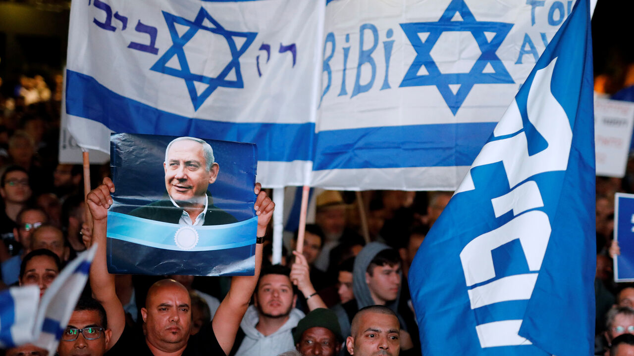 ISRAEL-NETANYAHU/DEMONSTRATION Supporters of Israeli Prime Minister Benjamin Netanyahu take part in a protest supporting Netanyahu after he was charged in corruption cases, in Tel Aviv, Israel November 26, 2019. The words in Hebrew read "Only Bibi". REUTERS/Amir Cohen - RC28JD93UD89