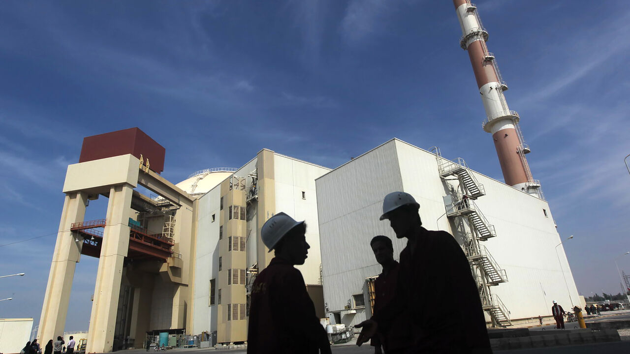 IRAN-NUCLEAR/FUEL Iranian workers stand in front of the Bushehr nuclear power plant, about 1,200 km (746 miles) south of Tehran October 26, 2010. Iran has begun loading fuel into the core of its first nuclear power plant on Tuesday, one of the last steps to realising its stated goal of becoming a peaceful nuclear power, state-run Press TV reported on Tuesday. REUTERS/Mehr News Agency/Majid Asgaripour (IRAN - Tags: POLITICS ENERGY IMAGES OF THE DAY) - GM1E6AQ1G1401