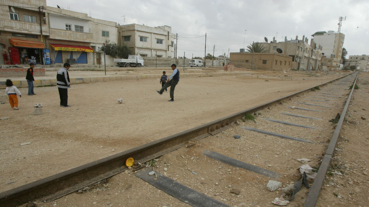 73574864 MAFRAQ, JORDAN- MARCH 14: Children play along disused parts of the Hejaz Railway on March 14, 2007 in Mafraq, Jordan. The railway is part of a broad regional collaboration project the Israeli government has approved, including the creation of a railway linking Jordan to the northern Israeli port of Haifa. Built by over 10,000 Turkish soldiers directed by German engineer Heinrich Meissner at the turn of the century, the railway was originally conceived as a means to transport Muslim pilgrims from Istanbul to