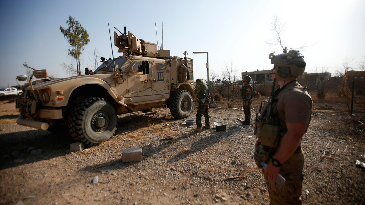 MIDEAST-CRISIS/IRAQ-BASHIQA U.S. military vehicles are seen in the town of Bashiqa, east of Mosul, during an operation to attack Islamic State militants in Mosul, Iraq, November 7, 2016. REUTERS/Azad Lashkari - S1AEULMKDCAB