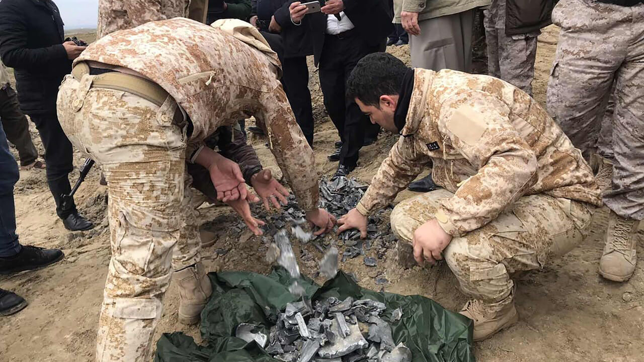 1192512579 ERBIL, IRAQ - JANUARY 08: Iraqi security forces find and collect the pieces of missiles as they gather to inspect the site after Iran's Islamic Revolutionary Guard Corps (IRGC) targeted Ain al-Asad airbase in Iraq, a facility jointly operated by U.S. and Iraqi forces, at Bardarash district of Erbil in Iraq on January 08, 2020. (Photo by Azad Muhammed/Anadolu Agency via Getty Images)