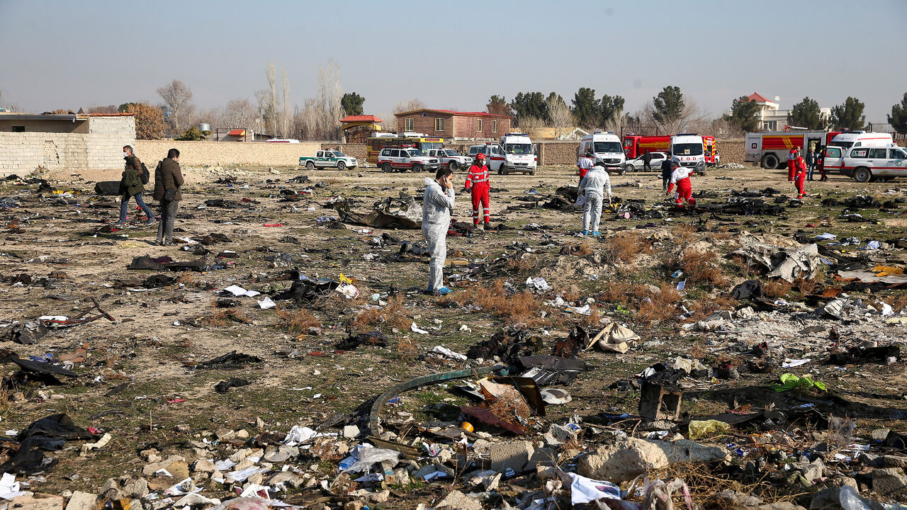 IRAN-CRASH/ Rescue team works among debris of a plane belonging to Ukraine International Airlines, that crashed after take-off from Iran's Imam Khomeini airport, on the outskirts of Tehran, Iran January 8, 2020. Nazanin Tabatabaee/WANA (West Asia News Agency) via REUTERS ATTENTION EDITORS - THIS IMAGE HAS BEEN SUPPLIED BY A THIRD PARTY - RC2MBE9I2565