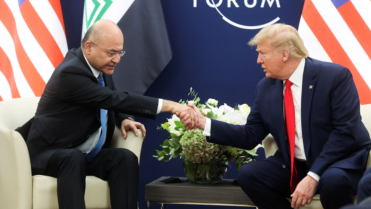 DAVOS-MEETING/TRUMP-IRAQ U.S. President Donald Trump shakes hands with Iraqi President Barham Salih as they hold bilateral talks during the 50th World Economic Forum (WEF) annual meeting in Davos, Switzerland, January 22, 2020. REUTERS/Jonathan Ernst - RC2YKE9TXDML