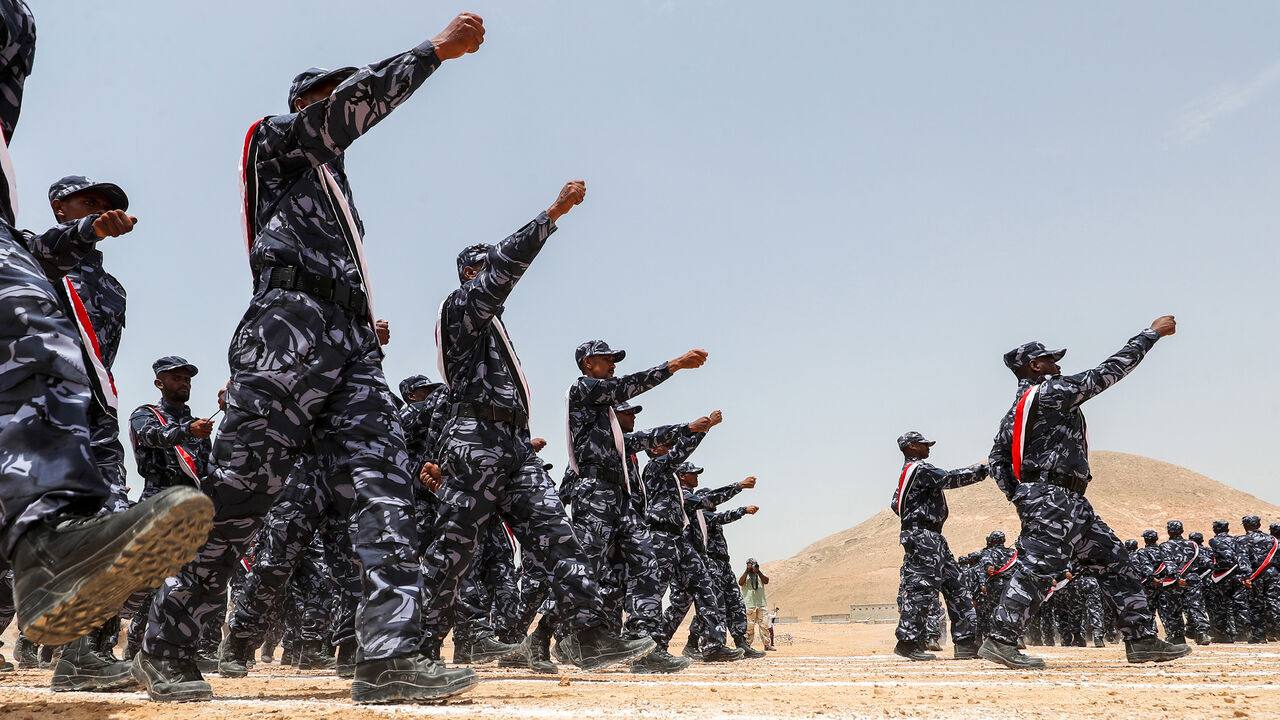 1016080666 A picture taken on August 8, 2018 during a trip in Yemen organised by the UAE's National Media Council (NMC) shows UAE-trained cadets of the Yemeni police, supporting forces loyal to the Saudi and UAE-backed government, marching during their graduation in the southeastern port city of Mukalla, the capital Hadramawt province, in the first such ceremony after the city was retaken from Al-Qaeda jihadists. (Photo by KARIM SAHIB / AFP) (Photo credit should read KARIM SAHIB/AFP via Getty Images)