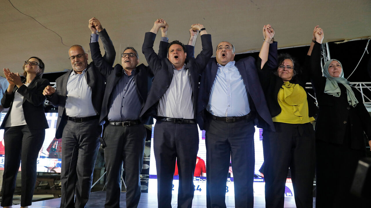 (L to R) Heba Yazbak, member and candidate for the Balad (National Democratic Alliance) party that is part of the Joint List alliance, applauds as Osama Saadi, member and candidate for the Arab Movement for Change (Taal) party raises his hands together with Balad party member and candidate Mtanes Shehadeh, Hadash (Democratic Front for Peace and Equality) party's chairman and candidate Ayman Odeh, Taal's leader and candidate Ahmad Tibi, Hadash's member and candidate Aida Touma, and the Islamic Movement's mem