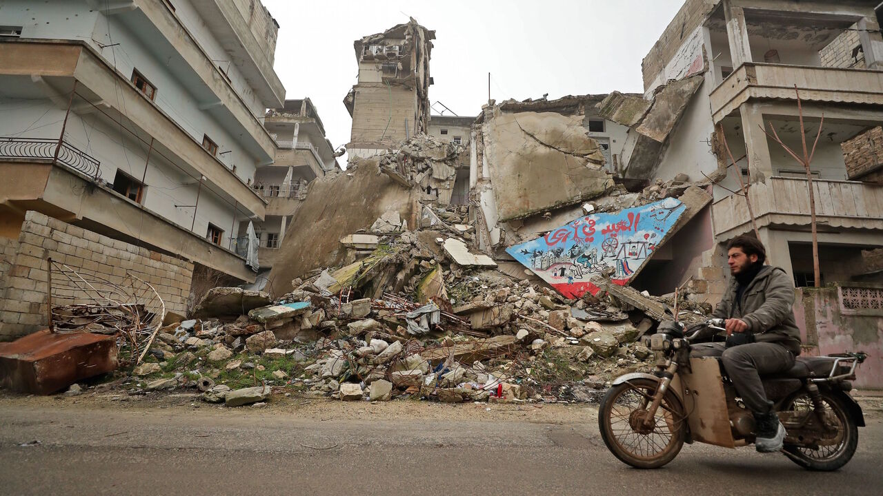 1198806569 A Syrian man rides his motorcycle past a damaged building following an air strike by pro-regime forces on the rebel-held town of Ariha in the northern countryside of Syria's Idlib province on February 5, 2020. - Syrian regime forces pressed on with their offensive in the northwest that has displaced half a million people, despite heightened tensions with Turkey.
Intensive aerial bombardment and ground fighting in the jihadist-dominated Idlib region since December have killed almost 300 civilians and trigger