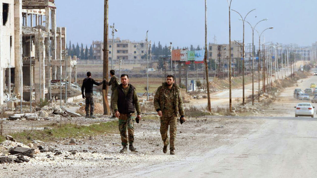 SYRIA-SECURITY/ Syrian army soldiers walk along a street in Aleppo province, Syria, in this handout released by SANA on February 17, 2020. SANA/Handout via REUTERS ATTENTION EDITORS - THIS IMAGE WAS PROVIDED BY A THIRD PARTY. REUTERS IS UNABLE TO INDEPENDENTLY VERIFY THIS IMAGE - RC2K2F9QWRFR