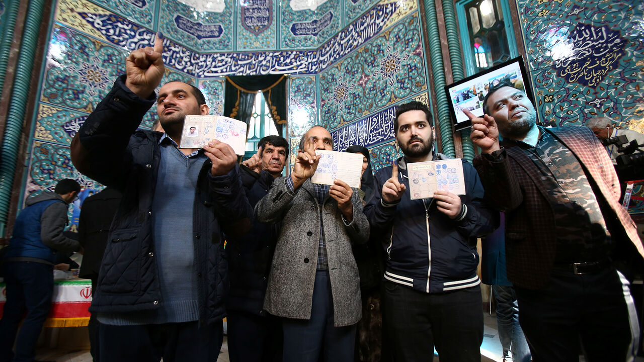 IRAN-ELECTION/ Iranians show their ink-stained fingers after they cast their votes during parliamentary elections at a polling station in Tehran, Iran February 21, 2020. Nazanin Tabatabaee/WANA (West Asia News Agency) via REUTERS ATTENTION EDITORS - THIS IMAGE HAS BEEN SUPPLIED BY A THIRD PARTY. - RC205F9PK7BA