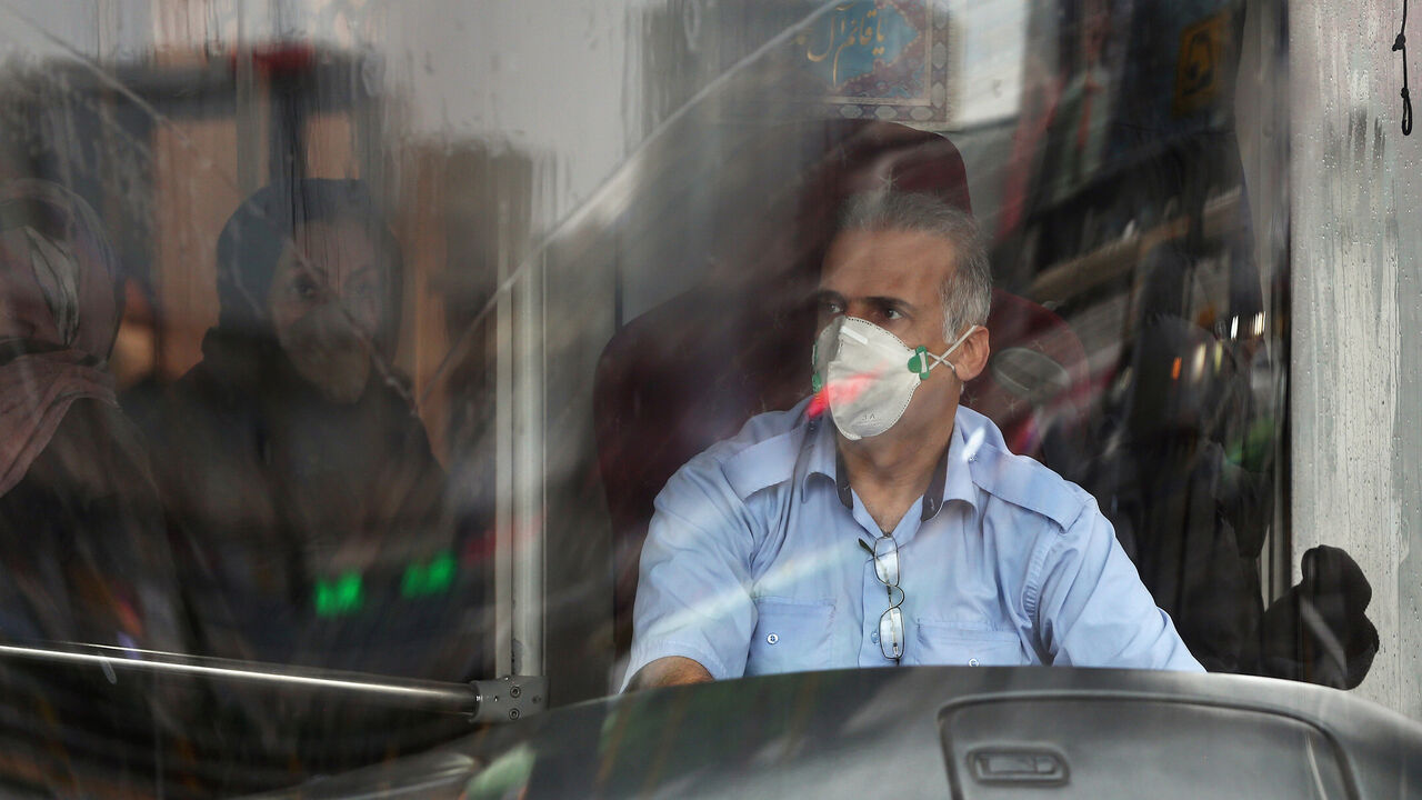 CHINA-HEALTH/IRAN A bus driver wears protective a mask to prevent contracting coronavirus, as he drives the bus in Tehran, Iran February 25, 2020. WANA (West Asia News Agency)/Nazanin Tabatabaee via REUTERS ATTENTION EDITORS - THIS IMAGE HAS BEEN SUPPLIED BY A THIRD PARTY. - RC2Q7F9BMNO8