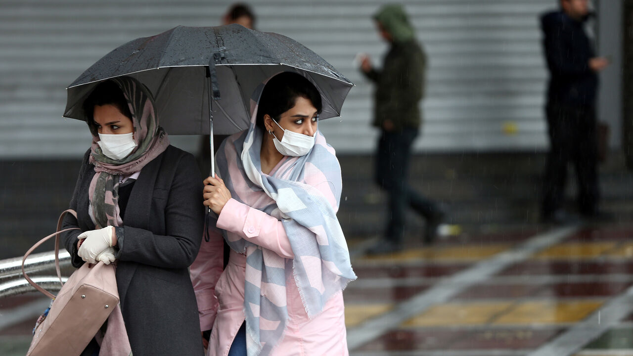 CHINA-HEALTH/IRAN Iranian women wear protective masks to prevent contracting coronavirus, as they walk in the street in Tehran, Iran February 25, 2020. WANA (West Asia News Agency)/Nazanin Tabatabaee via REUTERS ATTENTION EDITORS - THIS IMAGE HAS BEEN SUPPLIED BY A THIRD PARTY. - RC2Q7F9UZ1JB