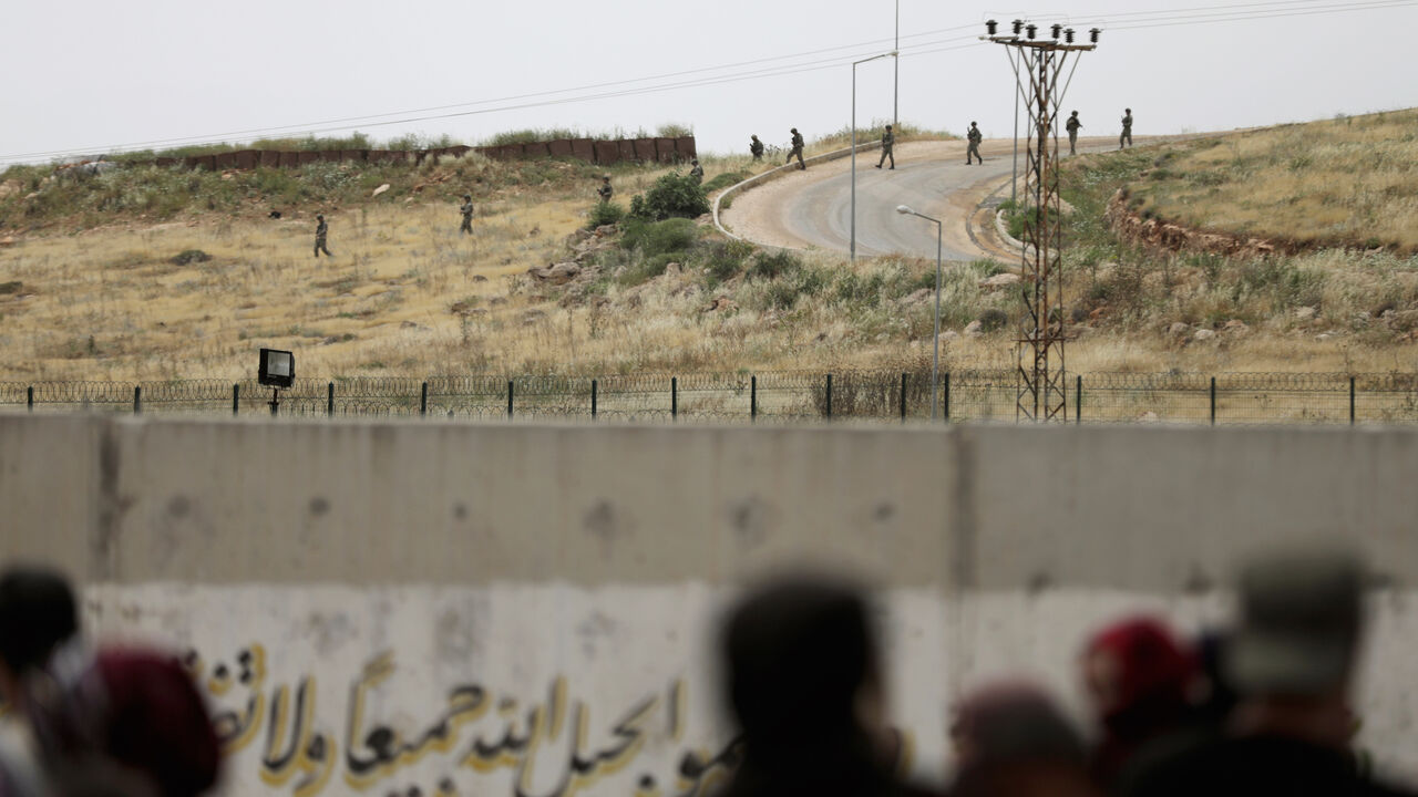 TURKEY-RUSSIA/SYRIA Turkish soldiers walk at the Atmeh crossing on the Syrian-Turkish border, as seen from the Syrian side, in Idlib governorate, Syria May 31, 2019. REUTERS/Khalil Ashawi - RC17B93A8C20