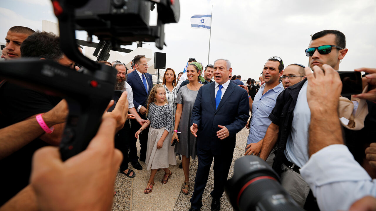 ISRAEL-ELECTION/ Members of the media work as Israeli Prime Minister Benjamin Netanyahu walks after holding a weekly cabinet meeting in the Jordan Valley, in the Israeli-occupied West Bank September 15, 2019. REUTERS/Amir Cohen - RC1DC97D0610